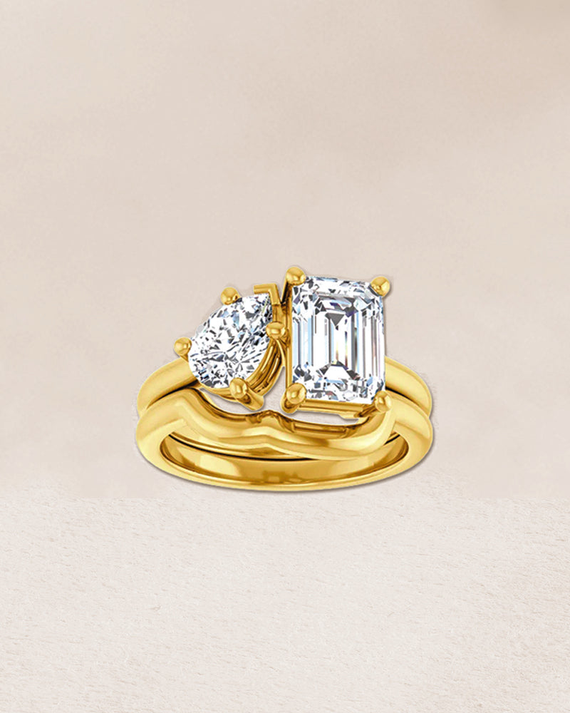 RGAÉL Refined Symmetry ring featuring an intertwined pear-shaped diamond and emerald-cut diamond.
